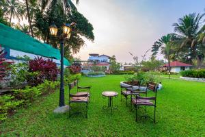 a group of chairs and a table and a street light at SaffronStays Adora Woods and Hills - 4BHK Murud Villa with Pool, Kids Pool & Beach Fun in Jambrung 