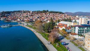 
a city with lots of buildings and a river at Hotel Nova Riviera in Ohrid
