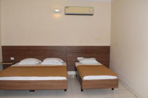 Postel nebo postele na pokoji v ubytování Hotel VPS Grand