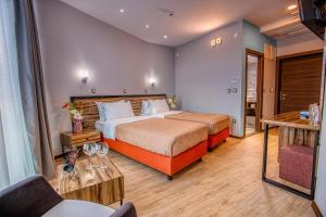 a hotel room with a bed and a table at Hotel Nova Riviera in Ohrid