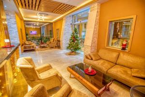 a living room with a couch and a christmas tree at Hotel Nova Riviera in Ohrid