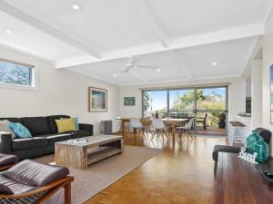 a living room with a couch and a table at Beaches at Culburra in Culburra Beach