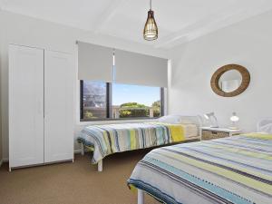 
A bed or beds in a room at Beaches @ Culburra - relax and recharge
