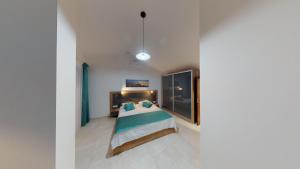 a bedroom with a large bed with blue pillows at Luka Villa in Becici