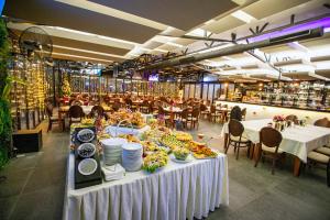 a dining room with a table with plates of food at Hotel Nova Riviera in Ohrid