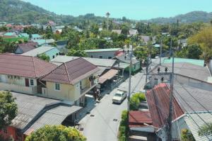 an aerial view of a town with houses and a street at Bangtao Corner in Bang Tao Beach