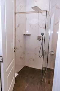 a bathroom with a shower with a glass door at HOTEL BALKAN in Bijeljina