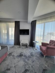 a living room with a couch and a table at Hotel Simona Halep - Mamaia Nord in Mamaia Sat/Năvodari