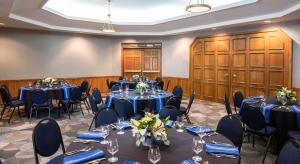 a room with tables and chairs in a room with wooden cabinets at Cherry Valley Hotel in Newark +56 photos