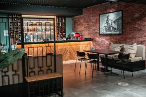 a bar with a table and chairs in a room at Snow Pine Suite - 4 Star Resort in Bakuriani