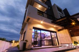 a building with a large glass door in front of it at Xiao Tian Di Homestay in Taitung City