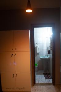 a bathroom with a sink and a toilet and a cabinet at Hostel Dunas in Florianópolis