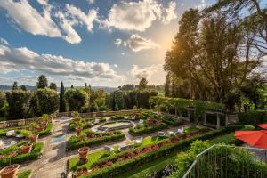 a garden filled with lots of flowers on a sunny day at Il Salviatino in Florence