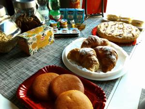 a table topped with plates of pastries and pies at B&B Villa Hermes in Sarno