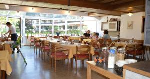 a restaurant with tables and chairs and people sitting at them at Gasthof Hotel zur Post in Kiefersfelden