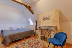 a bedroom with a bed and a fireplace at Calvaloft in Bons-Tassily