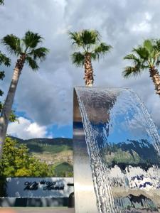 a water fountain with palm trees in the background at B&B Villa Hermes in Sarno