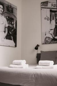 a bed with three stacks of towels on top of it at Super central in Brussels in Brussels
