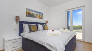 Postel nebo postele na pokoji v ubytování villa GOLDEN ROSE