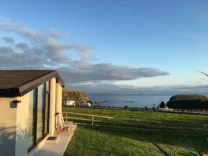 a house with a view of the ocean at Silver Strand Chalets in Glencolumbkille