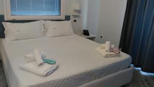 a bedroom with a bed with towels on it at Hotel Calypso in Pontecagnano