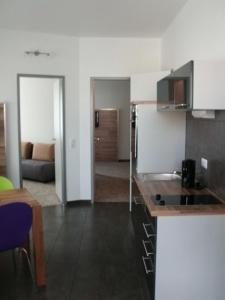 a kitchen with a counter top in a room at Petul Apart Hotel Am Ruhrbogen in Bochum