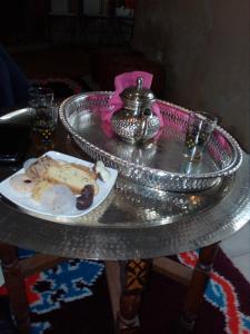 a silver table with a plate of food on it at Room in Guest room - Gite Tawada - Happy Valley - Room for 3 People in Agouti
