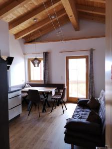 a living room with a table and a couch at Haus Kristall in Alpbach