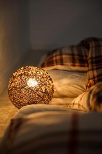 a lamp sitting on top of a bed at HAT Huruichi, near from Nara park, more than 5 parking space, 築3年の一軒家,駐車場5台以上可,グループでの宿泊に in Nara