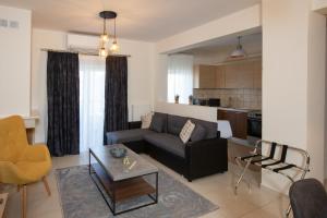a living room with a couch and a table at V Luxury Apartment 1 in Ioannina