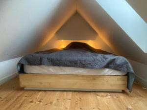 a bed sitting in the middle of a room at Aarhus lejlighed med udsigt in Aarhus