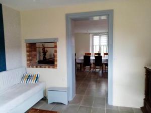 a living room with a couch and a dining room at Maison de 4 chambres avec jardin clos et wifi a Saint Vaast d'Equiqueville 