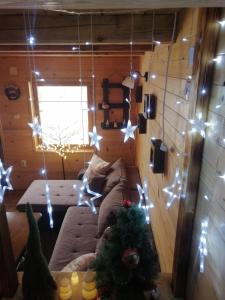 a living room with a couch and christmas lights at Brvnara Fruska Koliba in Vrdnik