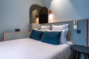 Postel nebo postele na pokoji v ubytování O.Lysée Hotel
