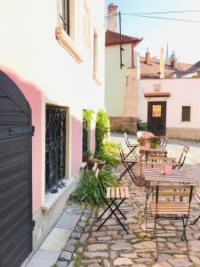 a patio with chairs and tables and a building at Boutique Apartments U Rolanda in Znojmo
