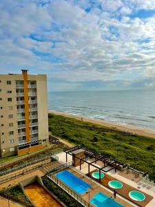 an aerial view of a hotel and the beach at BarraVilha Resort Vista Mar e Pé na Areia in Barra Velha