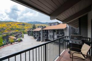 a balcony with a view of a town at Updated 3 BR, 2 BA with Pool & Hot Tub - Stunning Mountain Views! in Snowmass Village