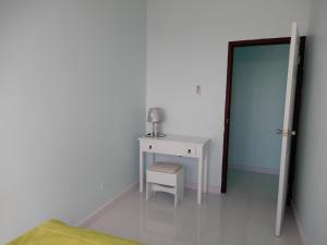 a bedroom with a table and a chair and a mirror at Oistins Bayview Apartments in Christ Church