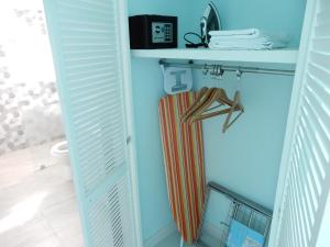 a bathroom with a towel rack and a radiator at Oistins Bayview Apartments in Christ Church