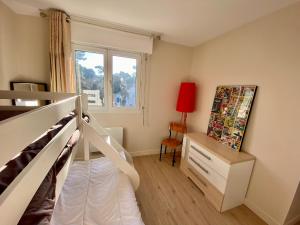 - une chambre avec des lits superposés et une fenêtre dans l'établissement Appartement spacieux à Pontaillac, proche plage, à Royan