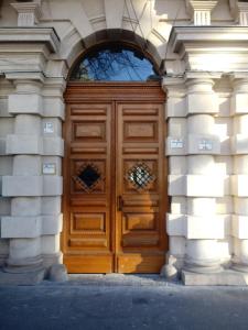 a large wooden door in a building at Andrassy Boulevard in Budapest