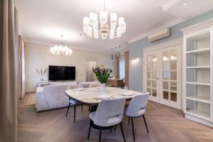 a dining room with a table and chairs at Luxury 2BDR Heart Of Old Town in Vilnius