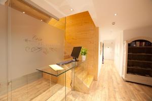 a office with a glass desk with a computer on it at Casa Nicolasa in Donostia-San Sebastián