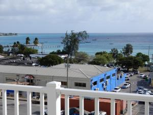 a view of a parking lot and the ocean at Oistins Bayview Apartments in Christ Church