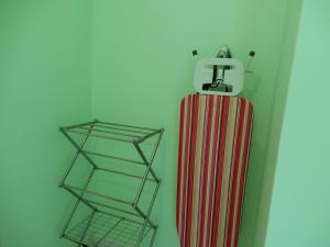 a red and white radiator hanging on a wall at Oistins Bayview Apartments in Christ Church
