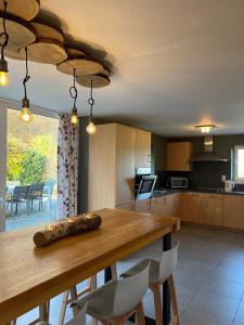 a kitchen with a wooden table and a dining room at Gite Du Moulin Coquelicot in Stavelot