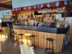 a bar with stools in front of a counter at hotel la rua in Albiez-Montrond