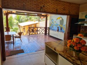 a kitchen with a large glass door leading to a patio at Casa Grande de Férias in Uruau