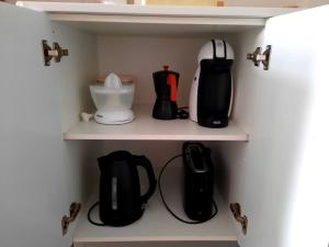 a shelf with various appliances in a kitchen at El Roquete, Feel the Sea in Gáldar