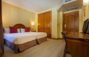 Postelja oz. postelje v sobi nastanitve Hotel Sant Gothard
